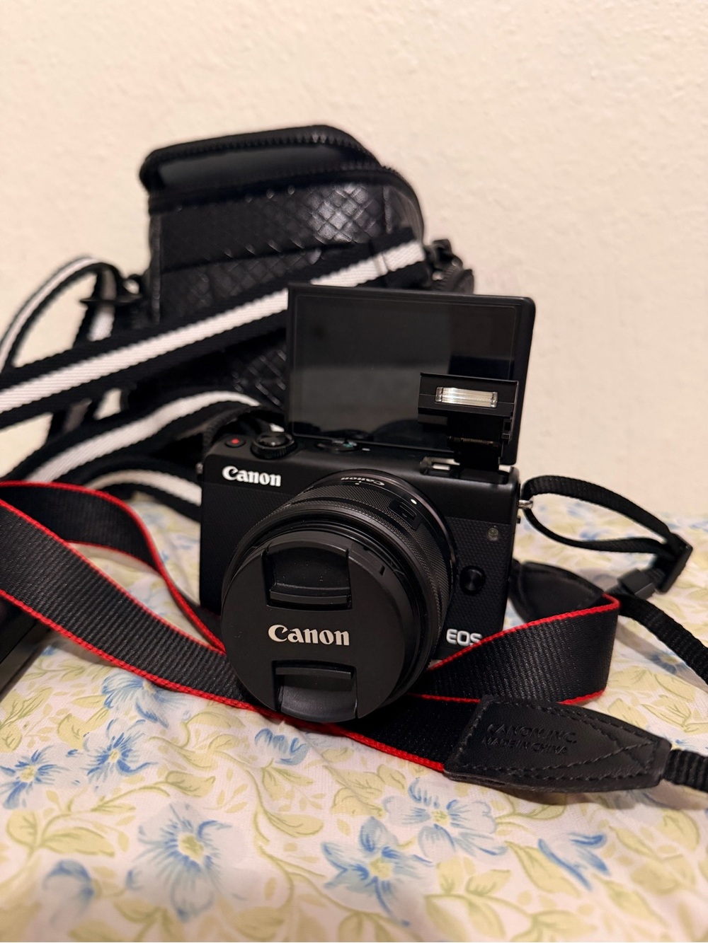 Canon Black Mirrorless EOS Camera with Red-Trim Strap